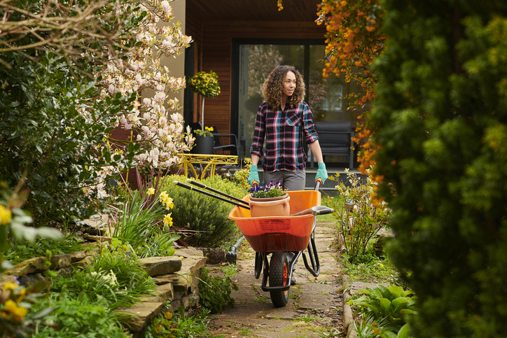 woman taking her tools into her garden