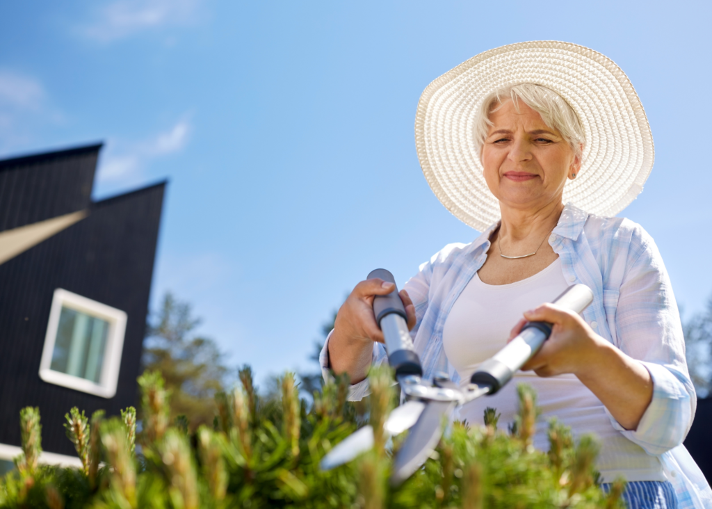 lady wearing wide brimmed hat while gardening