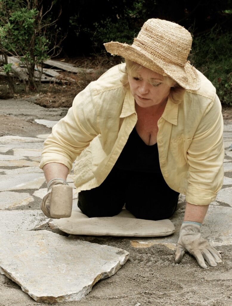 woman laying a stone path....definitely a great project to do in Florida's winter