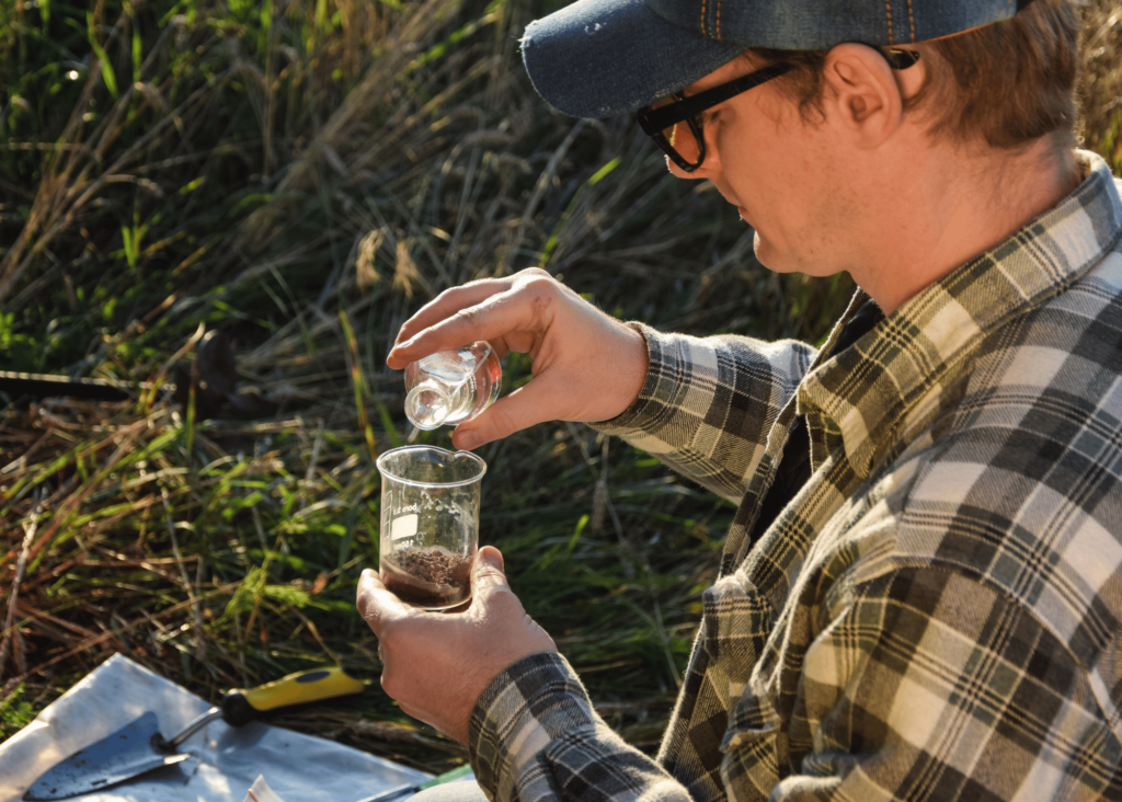 stock photo a man testing the soil